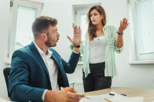Two business partners arguing after one make unauthorized withdrawals from the joint business account